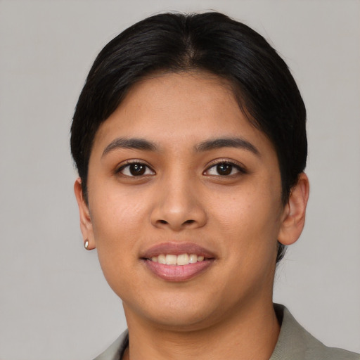 Joyful asian young-adult female with short  brown hair and brown eyes