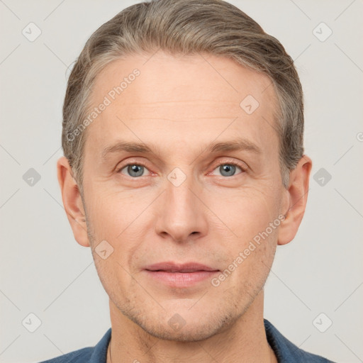 Joyful white adult male with short  brown hair and grey eyes