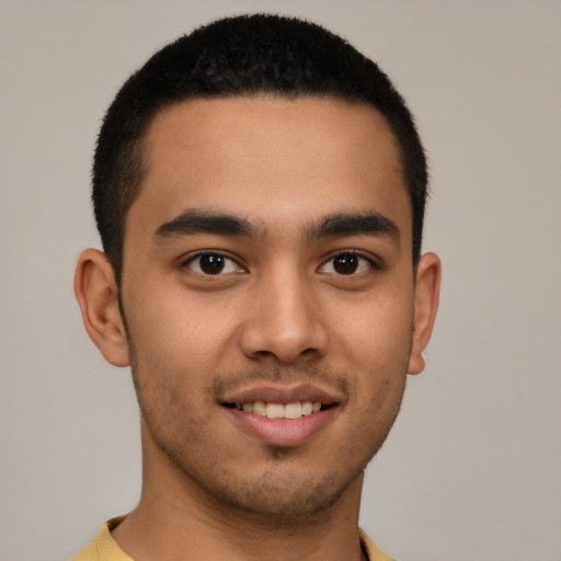 Joyful latino young-adult male with short  brown hair and brown eyes