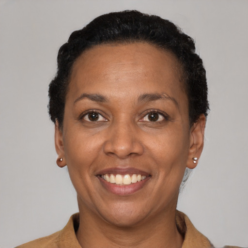 Joyful black adult female with short  black hair and brown eyes
