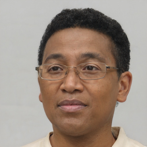Joyful latino adult male with short  brown hair and brown eyes