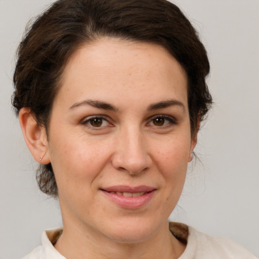 Joyful white adult female with short  brown hair and brown eyes