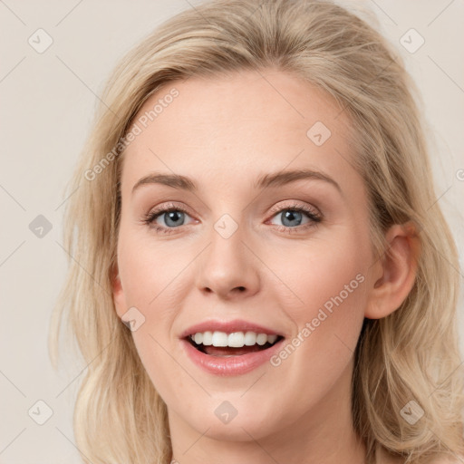 Joyful white young-adult female with long  brown hair and blue eyes