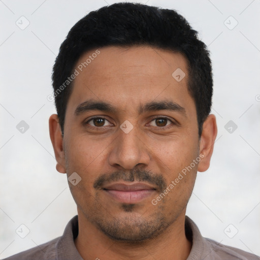 Joyful latino young-adult male with short  black hair and brown eyes