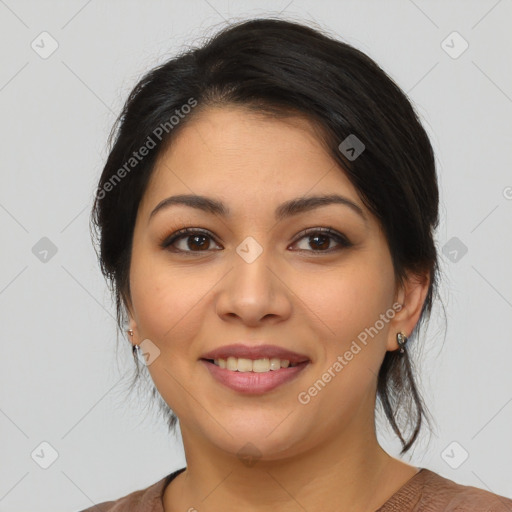 Joyful latino young-adult female with medium  brown hair and brown eyes