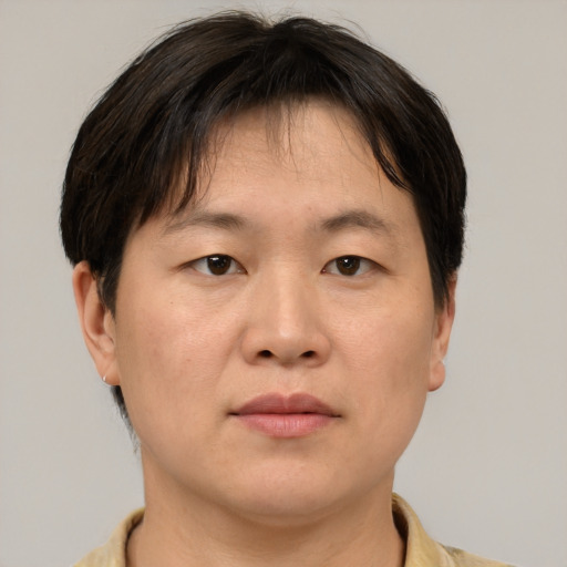 Neutral asian adult male with short  brown hair and brown eyes