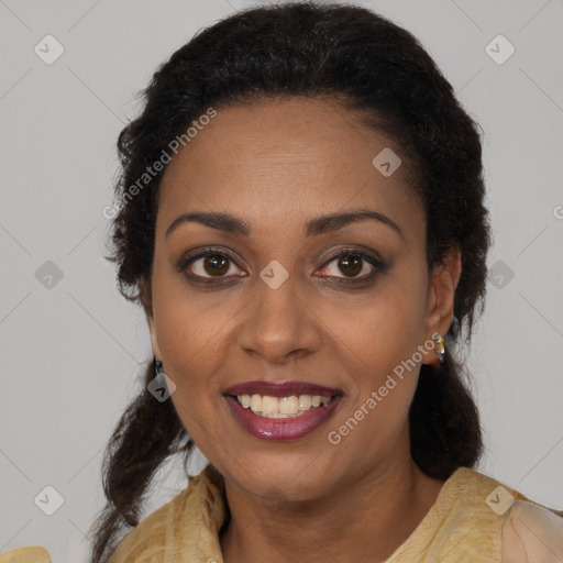 Joyful black young-adult female with long  brown hair and brown eyes