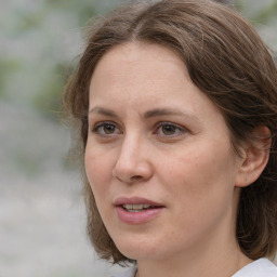 Joyful white adult female with medium  brown hair and grey eyes