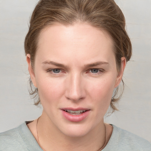 Joyful white young-adult female with medium  brown hair and blue eyes