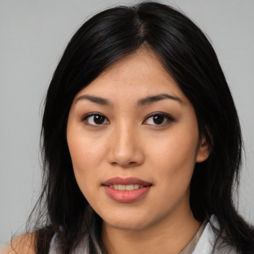 Joyful asian young-adult female with long  black hair and brown eyes