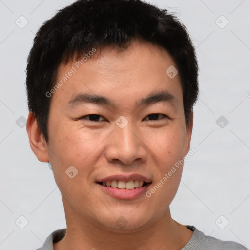 Joyful asian young-adult male with short  brown hair and brown eyes