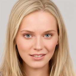 Joyful white young-adult female with long  brown hair and blue eyes