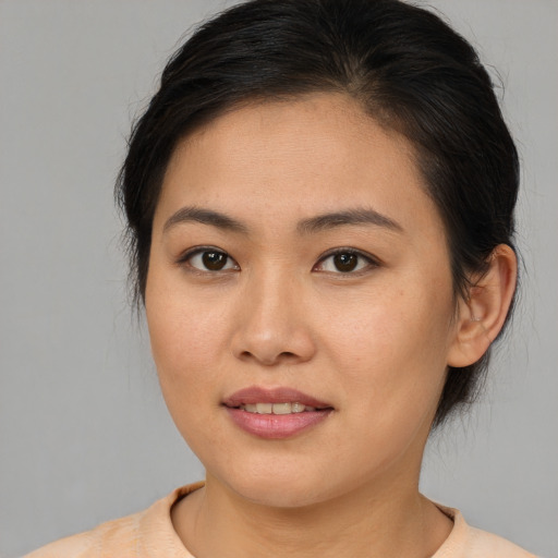 Joyful asian young-adult female with medium  brown hair and brown eyes