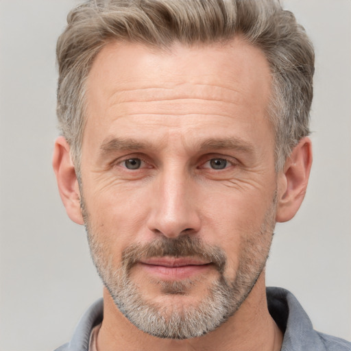 Joyful white middle-aged male with short  brown hair and brown eyes