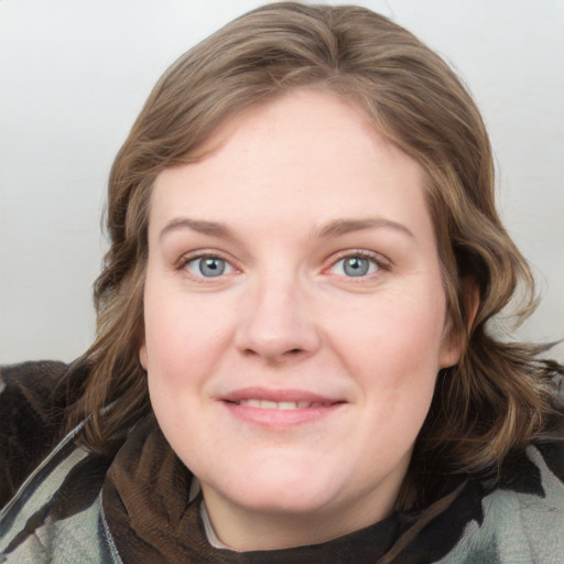 Joyful white young-adult female with medium  brown hair and blue eyes