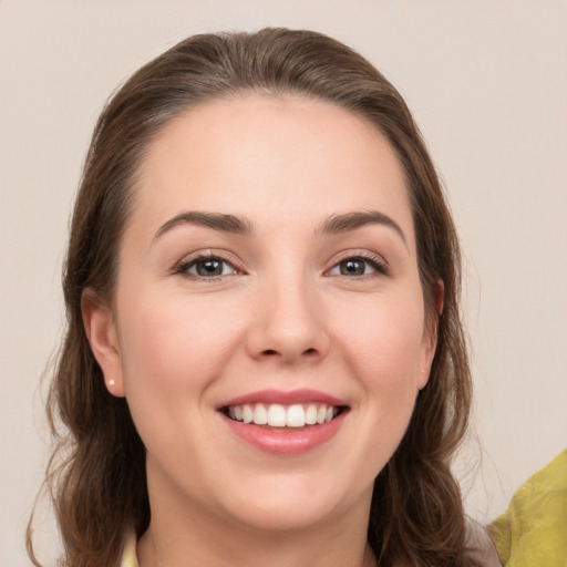 Joyful white young-adult female with medium  brown hair and grey eyes