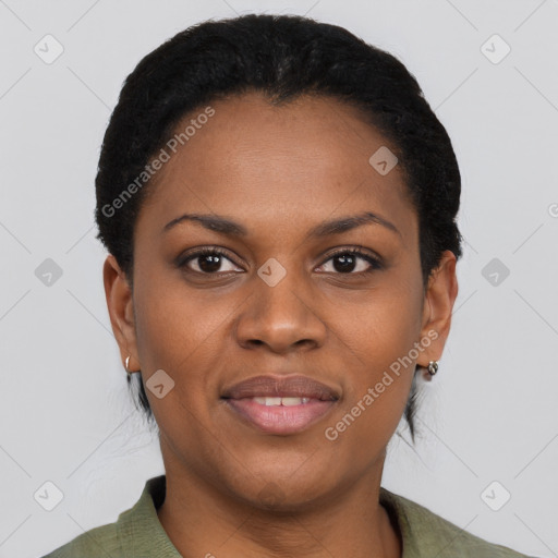 Joyful black adult female with short  black hair and brown eyes