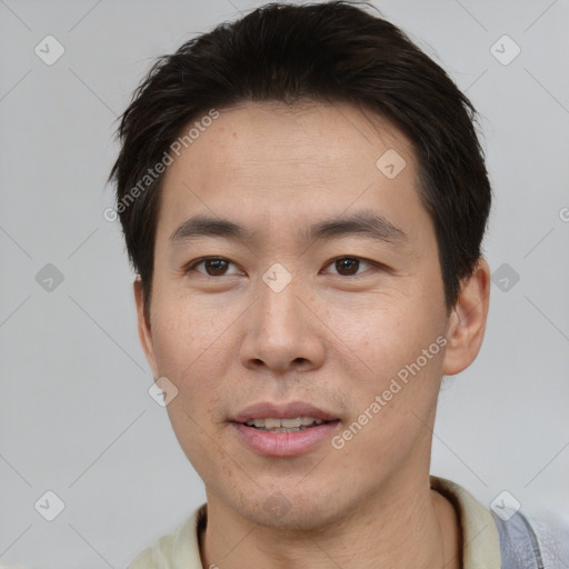 Joyful asian young-adult male with short  brown hair and brown eyes