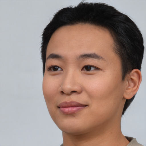 Joyful asian young-adult female with short  black hair and brown eyes