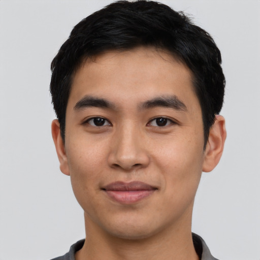 Joyful asian young-adult male with short  black hair and brown eyes