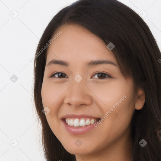 Joyful white young-adult female with long  brown hair and brown eyes