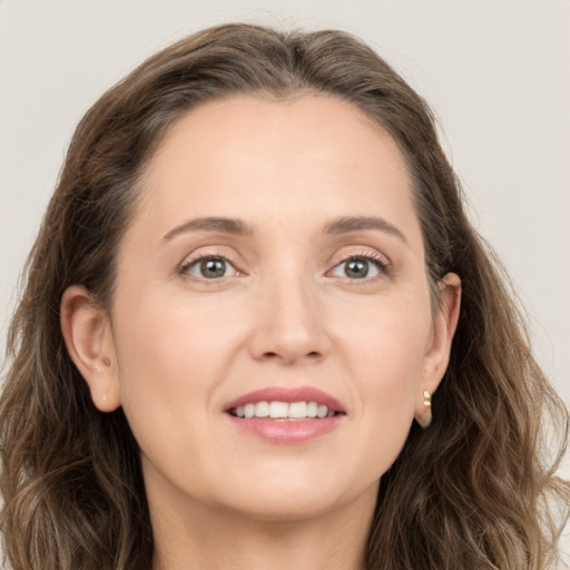 Joyful white young-adult female with long  brown hair and grey eyes