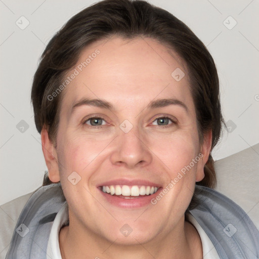 Joyful white adult female with short  brown hair and grey eyes