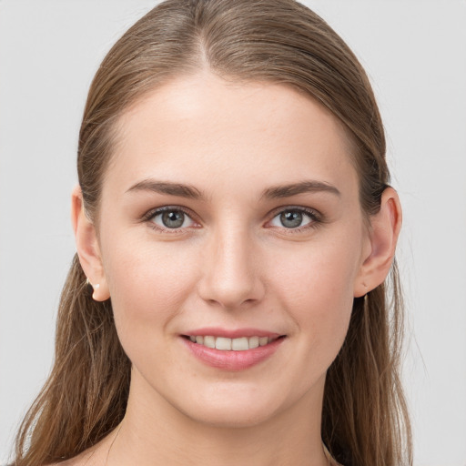 Joyful white young-adult female with long  brown hair and grey eyes