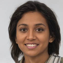 Joyful latino young-adult female with long  brown hair and brown eyes