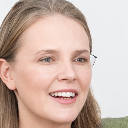 Joyful white young-adult female with long  brown hair and blue eyes