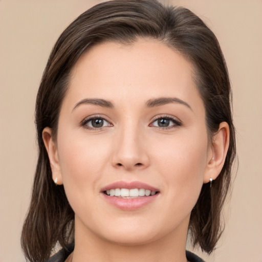 Joyful white young-adult female with medium  brown hair and brown eyes