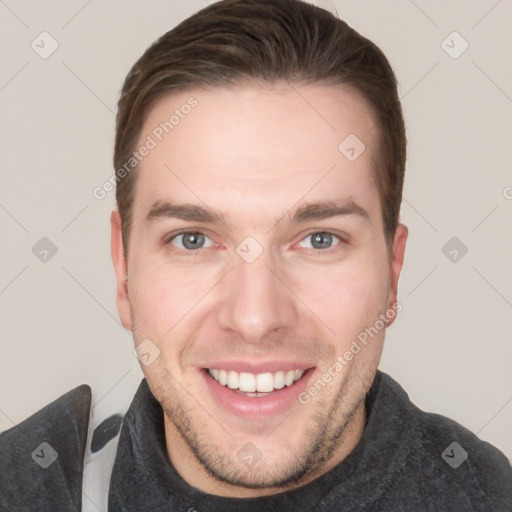 Joyful white young-adult male with short  brown hair and grey eyes