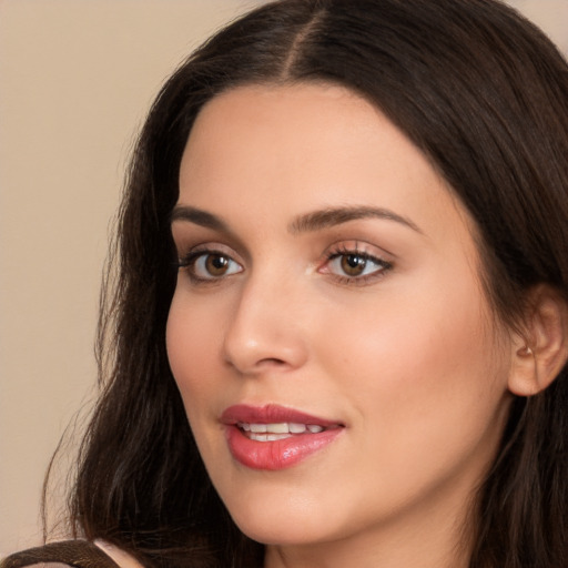 Joyful white young-adult female with long  brown hair and brown eyes