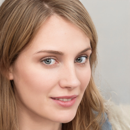 Joyful white young-adult female with long  brown hair and blue eyes