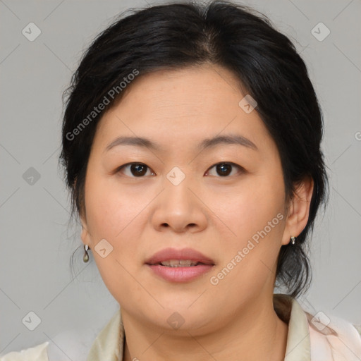 Joyful asian adult female with medium  brown hair and brown eyes