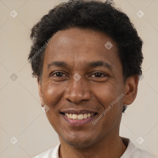 Joyful latino adult male with short  brown hair and brown eyes