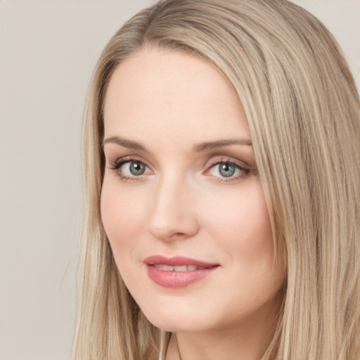 Joyful white young-adult female with long  brown hair and blue eyes