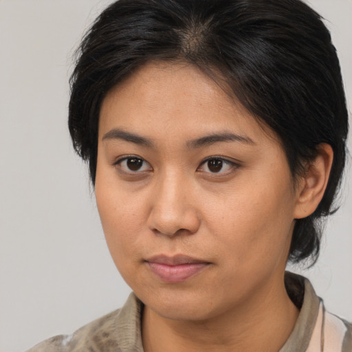 Neutral asian young-adult female with medium  brown hair and brown eyes