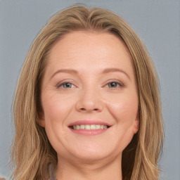 Joyful white young-adult female with long  brown hair and blue eyes