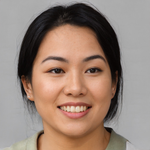 Joyful asian young-adult female with medium  black hair and brown eyes