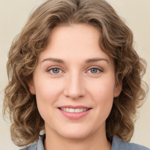 Joyful white young-adult female with medium  brown hair and green eyes