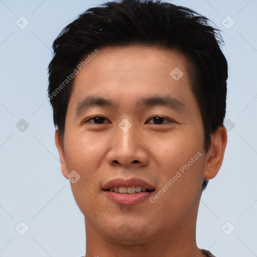 Joyful asian young-adult male with short  black hair and brown eyes