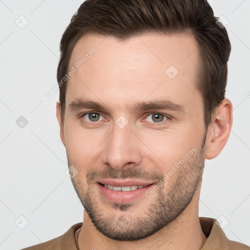 Joyful white young-adult male with short  brown hair and brown eyes