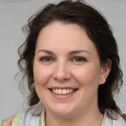 Joyful white adult female with medium  brown hair and brown eyes