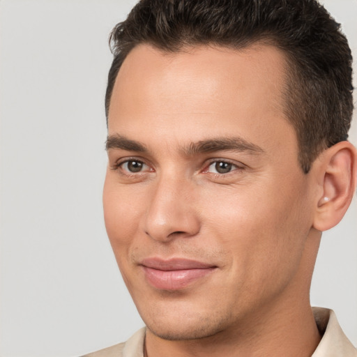 Joyful white young-adult male with short  brown hair and brown eyes