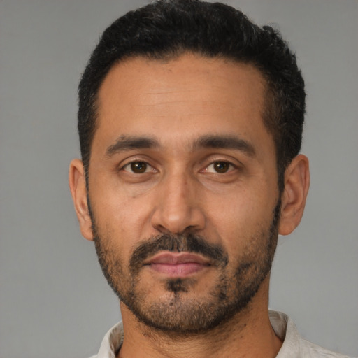 Neutral latino adult male with short  black hair and brown eyes