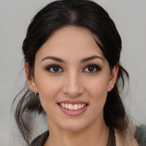 Joyful white young-adult female with long  black hair and brown eyes