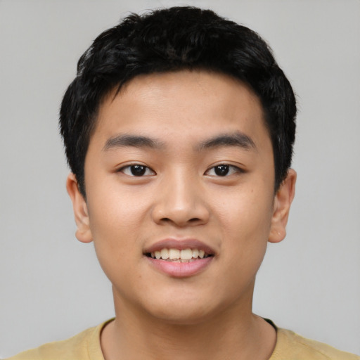 Joyful asian young-adult male with short  black hair and brown eyes