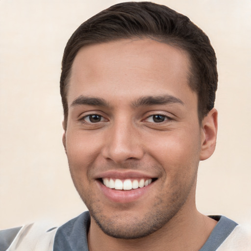 Joyful white young-adult male with short  brown hair and brown eyes