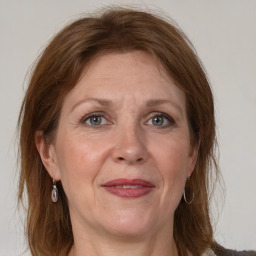 Joyful white adult female with medium  brown hair and grey eyes